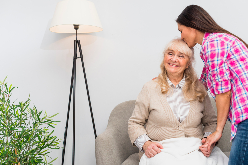Friendly carer supporting an elderly person at home, representing Quality Care Zone’s domiciliary care Staffordshire services.